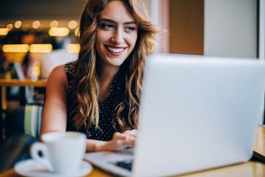 Smiling young woman in coffee shop